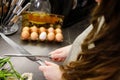 Woman sharpening kitchen knife with grindstone in the kitchen, kitchen knife. Close up view on hands