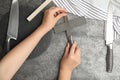 Woman sharpening knife at table, top view Royalty Free Stock Photo