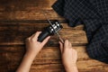 Woman sharpening knife at wooden table