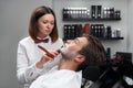 Woman shaves beard razor