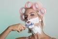Woman shaves her face Royalty Free Stock Photo
