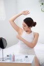 Woman shaving her armpit with white shaver Royalty Free Stock Photo