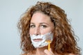 Woman shaving her beard Royalty Free Stock Photo