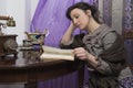 Woman with shawl intent on reading