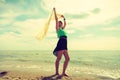 Woman with shawl running on beach