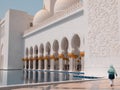 Woman at Sheikh Zayed Grand Mosque in Abu Dhabi, UAE at Reflection Pool