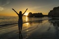 Woman shilouette with wihite dress at sunset in Algarve, Portugal Royalty Free Stock Photo