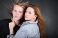 Woman in shirt hug long hair boy in photo studio Royalty Free Stock Photo