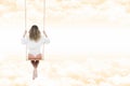 Woman with shirt and white pants on the swing through the clouds Royalty Free Stock Photo