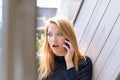 Woman shocked during conversation on mobile phone Royalty Free Stock Photo