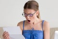 Woman shocked when reading letter with bad news Royalty Free Stock Photo