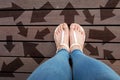 Woman Shoes with Drawn Direction Arrows Choices. Woman Feet and Sandal Standing on Wooden Floor Background Royalty Free Stock Photo