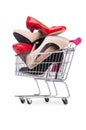 Woman shoes in shopping cart on white Royalty Free Stock Photo