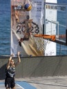 Woman shooting basketball on seaside court, Limassol, Cyprus