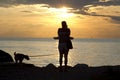 Woman shooting with camera at sunset Royalty Free Stock Photo