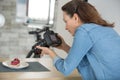 woman shooting man in apron with fresh cakes and pastries Royalty Free Stock Photo