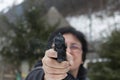 Woman shooting outdoor with a gun Royalty Free Stock Photo