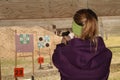 Woman shooting target at pistol shooting range