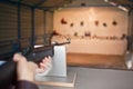 Woman shoots a gun at a shooting range Royalty Free Stock Photo