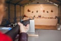 Woman shoots a gun at a shooting range Royalty Free Stock Photo