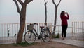 A woman shoots nature near a bicycle