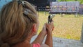 Woman shoots at shooting range with pneumatic gun. Outdoors entertainment for tourists in Thailand.Active leisure on Royalty Free Stock Photo