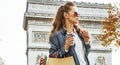 Woman shopper near Arc de Triomphe having coffee and macaroon Royalty Free Stock Photo