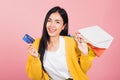 Woman shopper smiling standing excited holding online shopping bags colorful and credit card Royalty Free Stock Photo