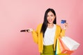 Woman shopper smiling standing excited holding online shopping bags colorful and credit card Royalty Free Stock Photo