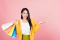 Woman shopper smiling standing holding shopping bags multicolor in summer show something hand palm Royalty Free Stock Photo