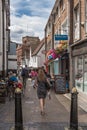 Woman shopper walks down the historic French Row passed cafes and outdoor diners