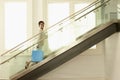 Woman With Shopping Bag On Modern Glass Stairs Royalty Free Stock Photo