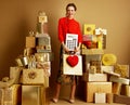 Woman with shopping bag, red heart and big white calculator Royalty Free Stock Photo