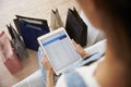 Woman With Shopping Bags Checks Bank Statement On Digital Tablet Royalty Free Stock Photo