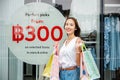 A woman with shopping bags in front of a store window