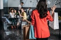 woman with shopping bags going to her friends