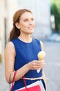 Woman with shopping bags and ice cream in city Royalty Free Stock Photo