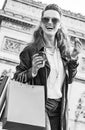 Woman with shopping bags in Paris having coffee and macaroon Royalty Free Stock Photo