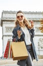 Woman with shopping bags in Paris having coffee and macaroon Royalty Free Stock Photo