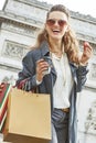 Woman with shopping bags in Paris having coffee and macaroon Royalty Free Stock Photo