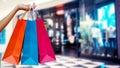 Woman with shopping bags in shopping mall.