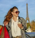 Woman with shopping bags and smartphone in Paris looking aside Royalty Free Stock Photo