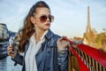 Woman with shopping bags and smartphone in Paris looking aside Royalty Free Stock Photo