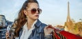 Woman with shopping bags and smartphone in Paris looking aside Royalty Free Stock Photo