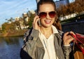 Woman with shopping bags talking on cell phone near Eiffel tower Royalty Free Stock Photo