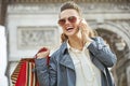 Woman with shopping bags talking on a smartphone in Paris Royalty Free Stock Photo