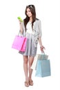 Woman with shopping bags while using mobile phone Royalty Free Stock Photo
