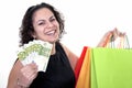 Woman shopping with bills of 100 euros