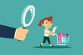 woman with shopping cart and big hand with magnifying glass behind her