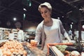 Woman with Shopping Cart Choosing Fruits in Shop. Royalty Free Stock Photo